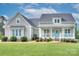 Inviting home featuring a classic porch with a cheerful, bright blue front door at 1327 Springlake Rd, York, SC 29745