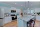 Well-lit kitchen featuring stainless steel appliances, an island, and ample counter space at 1327 Springlake Rd, York, SC 29745
