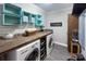 Well-organized laundry room with a butcher block countertop, modern appliances, and stylish decor at 1327 Springlake Rd, York, SC 29745