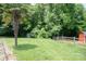 Large grassy backyard with mature trees, wood fence, and storage shed at 150 Wordsworth Way, Mooresville, NC 28115