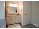 Bright bathroom features a vanity with granite countertop and white cabinets at 150 Wordsworth Way, Mooresville, NC 28115