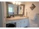 Bathroom vanity with granite countertop, decorative mirror, and a stylish stool at 150 Wordsworth Way, Mooresville, NC 28115
