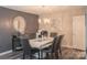 Elegant dining room features a modern chandelier, stylish mirror, and seating for six at 150 Wordsworth Way, Mooresville, NC 28115