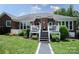 Brick home featuring an inviting outdoor patio with stairs, white railings, and manicured landscaping at 150 Wordsworth Way, Mooresville, NC 28115