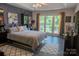 Spacious main bedroom with a large window view of the outdoor pool at 150 Wordsworth Way, Mooresville, NC 28115
