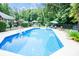 Backyard pool oasis with lounge seating, umbrellas, and lush greenery at 150 Wordsworth Way, Mooresville, NC 28115