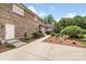 Brick exterior featuring an outdoor patio and lush landscaping at 1533 Ohara Plantation Ct, Dallas, NC 28034