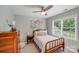 Comfortable bedroom with a wooden bed frame, ample storage, and a bright window, perfect for relaxation and rest at 1533 Ohara Plantation Ct, Dallas, NC 28034