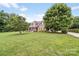 Charming two-story home with a large front yard, mature trees, and inviting curb appeal at 1533 Ohara Plantation Ct, Dallas, NC 28034