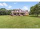 Inviting two-story home with a covered porch, landscaped yard, and classic brick exterior at 1533 Ohara Plantation Ct, Dallas, NC 28034