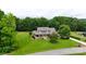 Stunning two-story home with a welcoming front porch, lush lawn, and mature trees at 1533 Ohara Plantation Ct, Dallas, NC 28034