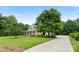 Landscaped home featuring a long driveway and lush lawn at 1533 Ohara Plantation Ct, Dallas, NC 28034