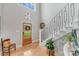 Bright foyer with hardwood floors, staircase, and a welcoming entryway showcasing natural light at 1533 Ohara Plantation Ct, Dallas, NC 28034