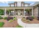 Inviting home entrance with a covered porch, brick facade, and landscaped walkway at 1533 Ohara Plantation Ct, Dallas, NC 28034