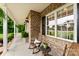 Charming front porch with rocking chairs, brick accents, and decorative plants creating a welcoming entrance at 1533 Ohara Plantation Ct, Dallas, NC 28034