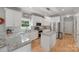 Bright kitchen featuring granite counters, white cabinets, and stainless steel appliances at 1533 Ohara Plantation Ct, Dallas, NC 28034