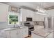 Well-lit kitchen with granite countertops, white cabinets, and modern appliances at 1533 Ohara Plantation Ct, Dallas, NC 28034