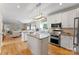 Modern kitchen with stainless steel appliances, a center island, and open layout to living room at 1533 Ohara Plantation Ct, Dallas, NC 28034