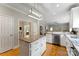 Bright kitchen featuring a center island, white cabinets, and stainless steel appliances at 1533 Ohara Plantation Ct, Dallas, NC 28034