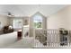 Upstairs landing boasts natural light and staircase with decorative railing at 1533 Ohara Plantation Ct, Dallas, NC 28034