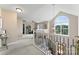 Bright upstairs landing with a large arched window and decorative railing at 1533 Ohara Plantation Ct, Dallas, NC 28034