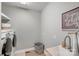 Well lit laundry room with washer, dryer, utility sink, and some shelves for storage at 1533 Ohara Plantation Ct, Dallas, NC 28034