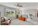 Bright and airy living room with large windows, a comfortable leather couch, and stylish decor, perfect for relaxation at 1533 Ohara Plantation Ct, Dallas, NC 28034