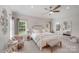 Bright main bedroom features a ceiling fan, windows, and access to main bathroom at 1533 Ohara Plantation Ct, Dallas, NC 28034