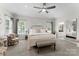 Spacious main bedroom with a decorative ceiling fan, bench seat, and ensuite bathroom at 1533 Ohara Plantation Ct, Dallas, NC 28034