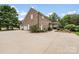 Expansive driveway, three-car garage, and outdoor living space with a pergola at 1533 Ohara Plantation Ct, Dallas, NC 28034