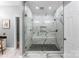 Beautiful primary bathroom with tile shower, dual showerheads, and a bench seat at 1533 Ohara Plantation Ct, Dallas, NC 28034