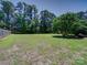 Picture of a large backyard surrounded by trees and a wooden fence creating a peaceful and secluded outdoor space at 1830 Huntington Pl, Rock Hill, SC 29732
