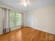 Cozy bedroom with a large window, hardwood floors, and a spacious closet at 1830 Huntington Pl, Rock Hill, SC 29732