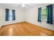 Sunny bedroom with hardwood floors and two windows providing ample natural light at 1830 Huntington Pl, Rock Hill, SC 29732