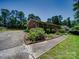 Spacious brick home with a wide driveway, mature trees, and a well-maintained landscaped yard at 1830 Huntington Pl, Rock Hill, SC 29732