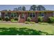 Charming brick home with shutters, landscaped front yard, and inviting steps leading to the entrance at 1830 Huntington Pl, Rock Hill, SC 29732