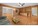 Inviting living room features a brick accent wall, built-in shelving, and hardwood floors at 1830 Huntington Pl, Rock Hill, SC 29732