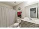 This bathroom includes a shower with a striped curtain, a toilet, and a sink at 2112 Balting Glass Dr, Indian Trail, NC 28079