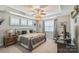 Comfortable bedroom with tray ceiling, fan, and ample natural light for rest and relaxation at 2112 Balting Glass Dr, Indian Trail, NC 28079