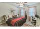 Well-lit bedroom featuring a ceiling fan, decorative ladder, and an adjacent desk area at 2112 Balting Glass Dr, Indian Trail, NC 28079