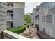 Balcony view of the building with lush greenery, stairs, and pathways at 226 Queens Rd # 68, Charlotte, NC 28204