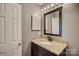 Well-lit bathroom featuring a granite vanity and a dark wood cabinet at 226 Queens Rd # 68, Charlotte, NC 28204