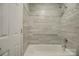 Updated bathroom featuring decorative tile work in the shower and tub combination, with modern fixtures at 226 Queens Rd # 68, Charlotte, NC 28204
