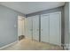 Bedroom featuring neutral carpet and large closets, offering ample storage and comfort at 226 Queens Rd # 68, Charlotte, NC 28204