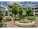 A charming courtyard showcases a decorative bench with lush landscaping and mature trees at 226 Queens Rd # 68, Charlotte, NC 28204