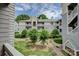 Scenic courtyard view surrounded by well-maintained landscaping and gray condos under a blue sky at 226 Queens Rd # 68, Charlotte, NC 28204