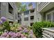 Beautiful condo community featuring colorful flowers, manicured hedges, and private balconies at 226 Queens Rd # 68, Charlotte, NC 28204