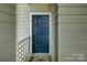 Inviting blue front door with secure entry and stylish welcome mat at 226 Queens Rd # 68, Charlotte, NC 28204