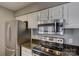 Modern kitchen with stainless steel appliances, granite countertops, and white cabinetry at 226 Queens Rd # 68, Charlotte, NC 28204
