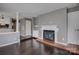 Open living room with fireplace, hardwood floors, and access to kitchen at 226 Queens Rd # 68, Charlotte, NC 28204